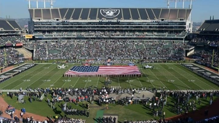 Nov 24, 2013; Oakland, CA, USA; General view of a United States flag on the field at O.co Coliseum during the playing of the national anthem as part of Salute to Service month festivities before the NFL game between the Tennessee Titans and the Oakland Raiders. Mandatory Credit: Kirby Lee-USA TODAY Sports