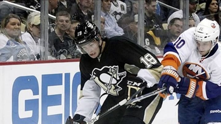 May 1, 2013; Pittsburgh, PA, USA; Pittsburgh Penguins right wing Beau Bennett (19) handles the puck as New York Islanders center Keith Aucoin (10) defends during the second period in game one of the first round of the 2013 Stanley Cup playoffs at CONSOL Energy Center. The Pittsburgh Penguins won 5-0. Mandatory Credit: Charles LeClaire-USA TODAY Sports