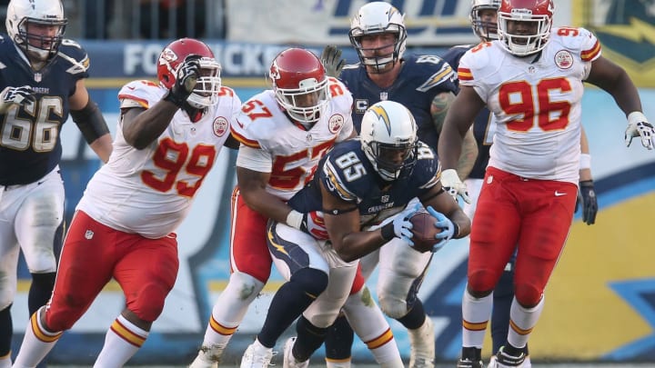 Tight end Antonio Gates #85 of the San Diego Chargers carries the ball after making a catch in overtime as he is tackled by linebacker Nico Johnson #57 of the Kansas City Chiefs  (Photo by Stephen Dunn/Getty Images)