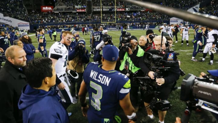 SEATTLE, WA - DECEMBER 03: Quarterback Carson Wentz #11 of the Philadelphia Eagles and quarterback Russell Wilson #3 of the Seattle Seahawks greet each other on the field after the game at CenturyLink Field on December 3, 2017 in Seattle, Washington. The Seattle Seahawks beat the Philadelphia Eagles 24-10. (Photo by Jonathan Ferrey/Getty Images)