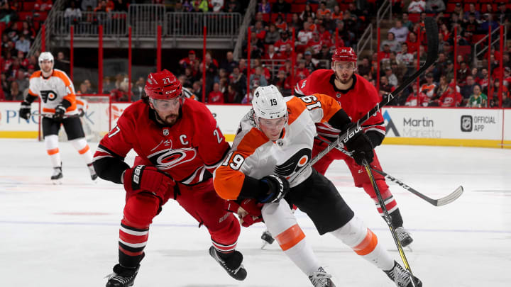 RALEIGH, NC – FEBRUARY 6: Justin Faulk #27 of the Carolina Hurricanes and Nolan Patrick #19 of the Philadelphia Flyers battle to control the puck during an NHL game on February 6, 2018 at PNC Arena in Raleigh, North Carolina. (Photo by Gregg Forwerck/NHLI via Getty Images)