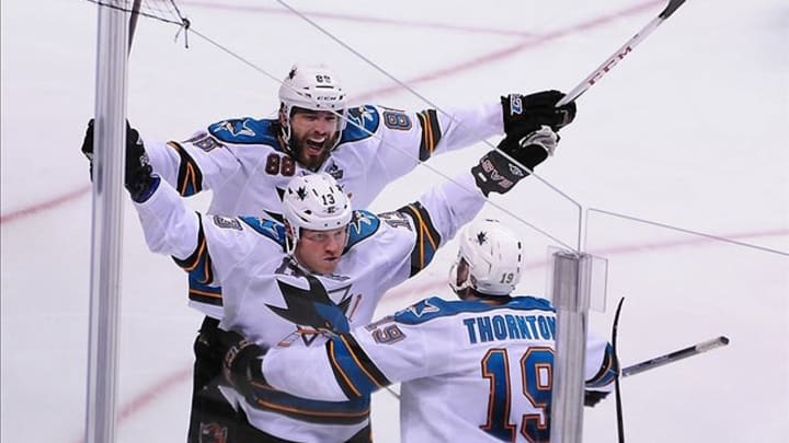 May 3, 2013; Vancouver, British Columbia, CAN; San Jose Sharks forward Raffi Torres (13) is congratulated by San Jose Sharks defenseman Brent Burns (88) and San Jose Sharks center Joe Thornton (19) after scoring the winning goal against Vancouver Canucks goaltender Roberto Luongo (1) (not pictured) during overtime of game two of the first round of the 2013 Stanley Cup playoffs at Rogers Arena. The San Jose Sharks won 3-2 in overtime. Mandatory Credit: Anne-Marie Sorvin-USA TODAY Sports