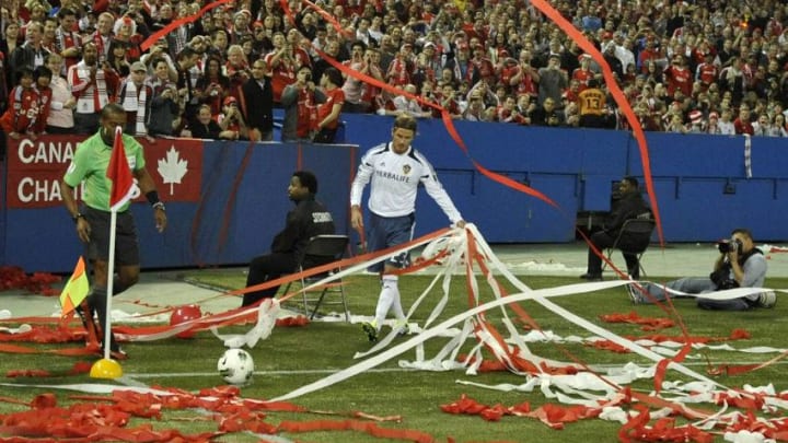 David Beckham #23 of the Los Angeles Galaxy removes streamers strewn on the pitch during CONCACAF Champions League game action against the Toronto FC. (Photo by Brad White/Getty Images)