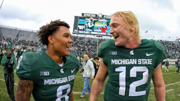 Oct 27, 2018; East Lansing, MI, USA; Michigan State Spartans quarterback Rocky Lombardi (12) and Michigan State Spartans wide receiver Jalen Nailor (8) walk off the field after a game against the Purdue Boilermakers at Spartan Stadium. Mandatory Credit: Mike Carter-USA TODAY Sports