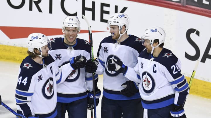 Mar 29, 2021; Calgary, Alberta, CAN; Winnipeg Jets forward Pierre-Luc Dubois (13) celebrates after scoring a third period goal against the Calgary Flames at Scotiabank Saddledome. The Jets won 5-1. Mandatory Credit: Candice Ward-USA TODAY Sports