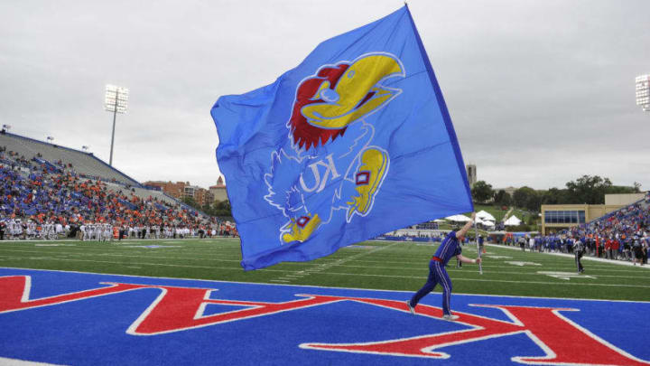 LAWRENCE, KS - SEPTEMBER 29: A Kansas Jayhawks cheerleaders runs with a Jayhawk flag after a touchdown against the Oklahoma State Cowboys at Memorial Stadium on September 29, 2018 in Lawrence, Kansas. (Photo by Ed Zurga/Getty Images)