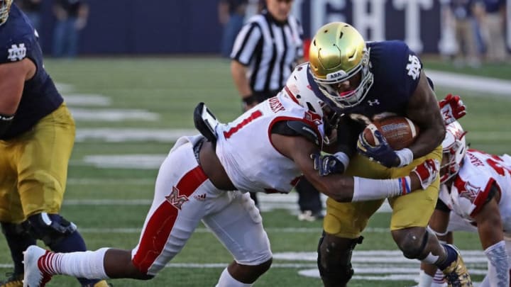 SOUTH BEND, IN - SEPTEMBER 30: Josh Adams #33 of the Notre Dame Fighting Irish brekas away from De'Andre Montgomery #21 of the Miami (Oh) Redhawks at Notre Dame Stadium on Seotember 30, 2017 in South Bend, Indiana. (Photo by Jonathan Daniel/Getty Images)