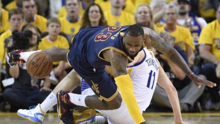 Jun 14, 2015; Oakland, CA, USA; Cleveland Cavaliers forward LeBron James (23) goes after a loose ball against Golden State Warriors guard Klay Thompson (11) during the fourth quarter in game five of the NBA Finals at Oracle Arena. Mandatory Credit: Bob Donnan-USA TODAY Sports