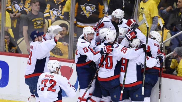 PITTSBURGH, PA - MAY 07: Washington Capitals Center Evgeny Kuznetsov (92) is mobbed by teammates after scoring the game winning goal during the overtime period. The Washington Capitals went on win 2-1 in the overtime period against the Pittsburgh Penguins in Game Six of the Eastern Conference Second Round during the 2018 NHL Stanley Cup Playoffs on May 7, 2018, at PPG Paints Arena in Pittsburgh, PA. The Capitals won the series 4-2 and advance to the Conference Finals. (Photo by Jeanine Leech/Icon Sportswire via Getty Images)