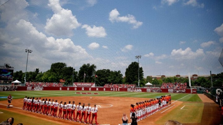 Players stand for the national anthem before the NCAA Norman Super Regional softball game between the University of Oklahoma Sooners and the Clemson Tigers at Marita Hynes Field in Norman, Okla., Friday, May, 26, 2023.