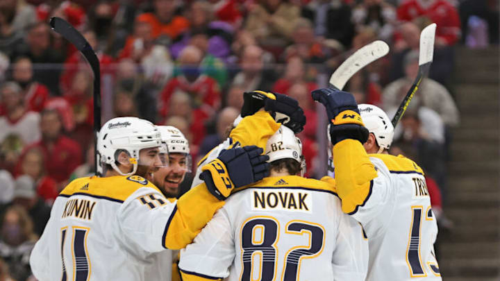 Thomas Novak #82 of the Nashville Predators is congratulated by teammates including Luke Kunin #11 and Yakov Trenin #13 after scoring a goal against the Chicago Blackhawks at the United Center on December 17, 2021 in Chicago, Illinois. The Predators defeated the Blackhawks 3-2 in overtime. (Photo by Jonathan Daniel/Getty Images)