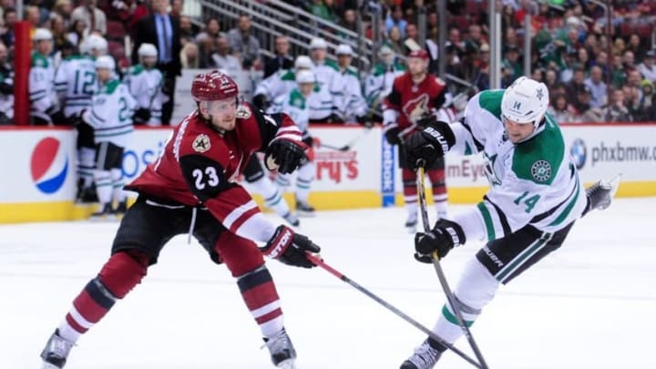 Mar 24, 2016; Glendale, AZ, USA; Dallas Stars left wing Jamie Benn (14) shoots as Arizona Coyotes defenseman Oliver Ekman-Larsson (23) defends during the third period at Gila River Arena. Mandatory Credit: Matt Kartozian-USA TODAY Sports