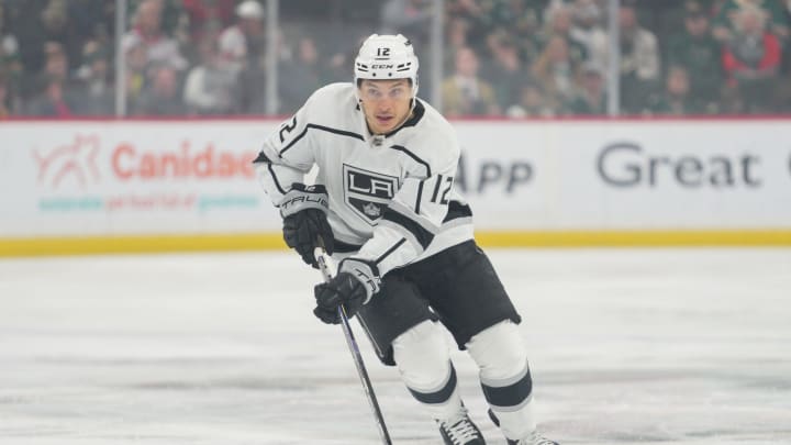 Feb 21, 2023; Saint Paul, Minnesota, USA; Los Angeles Kings left wing Trevor Moore (12) brings the puck into the Minnesota Wild zone in the first period at Xcel Energy Center. Mandatory Credit: Matt Blewett-USA TODAY Sports