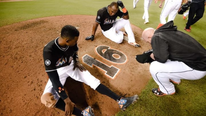 Sep 28, 2016; Miami, FL, USA; Miami Marlins second baseman Dee Gordon (left) center fielder Marcell Ozuna (top) and relief pitcher Mike Dunn (right) take a moment in honor of deceased Marlins starting pitcher Jose Fernandez at the pitchers mound after their game against the New York Mets at Marlins Park. The Mets won 5-2. Mandatory Credit: Steve Mitchell-USA TODAY Sports