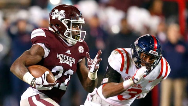 STARKVILLE, MS - NOVEMBER 23: Aeris Williams #22 of the Mississippi State Bulldogs carries the ball as he tries to elude the pursuit of DeMarquis Gates #3 of the Mississippi Rebels during the first half of an NCAA football game at Davis Wade Stadium on November 23, 2017 in Starkville, Mississippi. (Photo by Butch Dill/Getty Images)