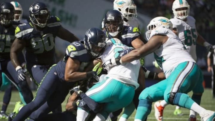 Sep 11, 2016; Seattle, WA, USA; Seattle Seahawks linebacker K.J. Wright (50) and linebacker Bobby Wagner (54) tackle Miami Dolphins running back Arian Foster (29) during the third quarter at CenturyLink Field. The Seahawks won 12-10. Mandatory Credit: Troy Wayrynen-USA TODAY Sports