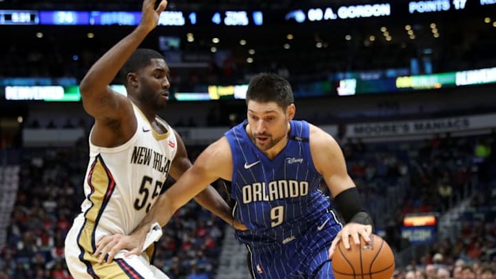 NEW ORLEANS, LA - OCTOBER 30: Nikola Vucevic #9 of the Orlando Magic drives the ball around E'Twaun Moore #55 of the New Orleans Pelicans at the Smoothie King Center on October 30, 2017 in New Orleans, Louisiana. NOTE TO USER: User expressly acknowledges and agrees that, by downloading and or using this photograph, User is consenting to the terms and conditions of the Getty Images License Agreement. (Photo by Chris Graythen/Getty Images)