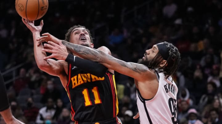 Dec 10, 2021; Atlanta, Georgia, USA; Atlanta Hawks guard Trae Young (11) tries to shoot over Brooklyn Nets guard DeAndre' Bembry (95) during the second half at State Farm Arena. Mandatory Credit: Dale Zanine-USA TODAY Sports