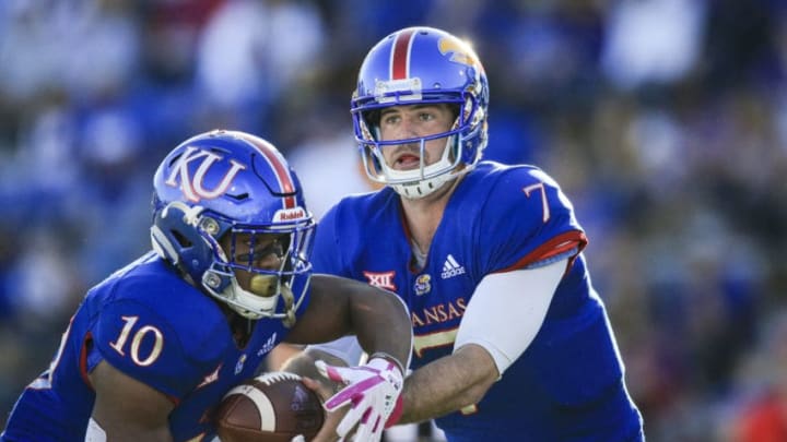 LAWRENCE, KS - OCTOBER 27: Peyton Bender #7 hands the ball to Khalil Herbert #10 of the Kansas Jayhawks for a play in the fourth quarter against the TCU Horned Frogs at Memorial Stadium on October 27, 2018 in Lawrence, Kansas. (Photo by Brian Davidson/Getty Images)