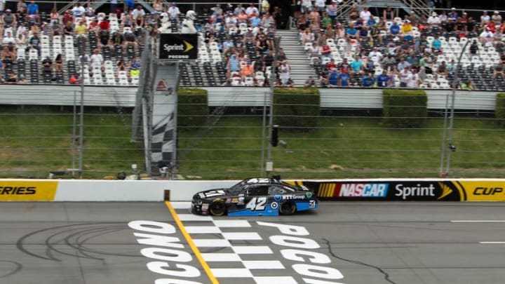 Jun 4, 2016; Long Pond, PA, USA; NASCAR XFINITY Series driver Kyle Larson (42) races during the Pocono Green 250 at Pocono Raceway. Mandatory Credit: Matthew O