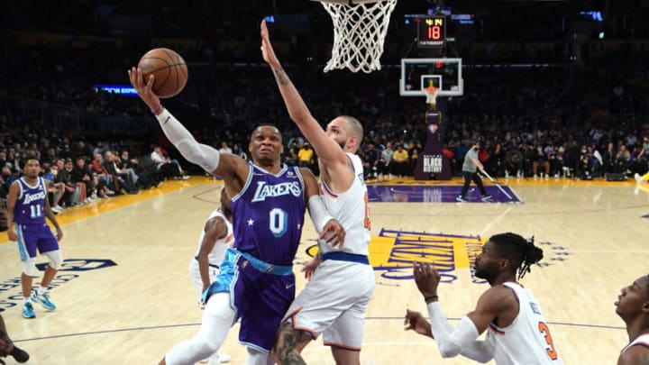 Feb 5, 2022; Los Angeles, California, USA; Los Angeles Lakers guard Russell Westbrook (0) misses a layup as he is defended by New York Knicks guard Evan Fournier (13) in the second half at Crypto.com Arena. Mandatory Credit: Jayne Kamin-Oncea-USA TODAY Sports