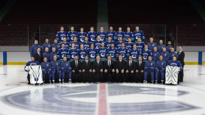 VANCOUVER, BC MARCH 12: (EDITORS NOTE: This image has been altered at the request of the Vancouver Canucks.) Members of the Vancouver Canucks (L-R) - Front Row - Jacob Markstrom #25, Ian Clark, Goaltending Coach, Manny Malhotra, Assistant Coach, Newell Brown, Assistant Coach, Jonathan Wall, Senior Director, Hockey Operations & Analytics, Chris Gear, Vice President and General Counsel, Trent Carroll, Chief Operating Officer, Francesco Aquilini, Chairman, Jim Benning, General Manager, John Weisbrod, Assistant General Manager, Stan Smyl, Senior Advisor to General Manager and Director Player Development, Travis Green, Head Coach, Nolan Baumgartner, Assistant Coach and Thatcher Demko #35. (L-R) - Second Row - Ben Brown, Director, Media Relations and Team Operations, Dave Zarn, Assistant Athletic Trainer, Jon Sanderson, Head Athletic Trainer, Jay Beagle #83, Elias Pettersson #40, Brock Boeser #6, Loui Eriksson #21, Alexander Edler #23, Christopher Tanev #8, Brandon Sutter #20, Bo Horvat #53, Antoine Roussel #26, Pat ONeill, Equipment Manager, Brian Hamilton, Assistant Equipment Manager, Mac Stewart, Equipment Assistant, Mike Brown, Senior Manager Team Services. (L-R) - Third Row - Darryl Seward, Video Coach, Glenn Carnegie, Skill Coach, Graeme Poole, Rehabilitation Therapist, Alex Biega #55, Markus Granlund #60, Ryan Spooner #15, Ben Hutton #27, Derrick Pouliot #5, Sven Baertschi #47, Troy Stecher #51, Tyler Motte #64, Nick Addey-Jibb, Athletic Trainer, Bryan Marshall, Strength and Development Coach, Roger Takahashi, Strength and Conditioning Coach. (L-R) Fourth Row - Tim Schaller #59, Guillaume Brisebois #56, Nikolay Goldobin #77, Adam Gaudette #88, Jake Virtanen #18, Josh Leivo #17, Tanner Pearson #70, Ashton Sautner #29 and Luke Schenn #2 pose for their official team photo at Rogers Arena on March 12, 2019 at Rogers Arena in Vancouver, British Columbia, Canada. (Photo by Jeff Vinnick/NHLI via Getty Images)