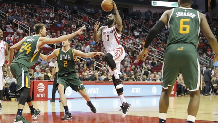 Nov 19, 2016; Houston, TX, USA; Houston Rockets guard James Harden (13) drives to the basket against Utah Jazz center Jeff Withey (24) and forward Joe Ingles (2) in the second half at Toyota Center. Rockets won 111-102. Mandatory Credit: Thomas B. Shea-USA TODAY Sports