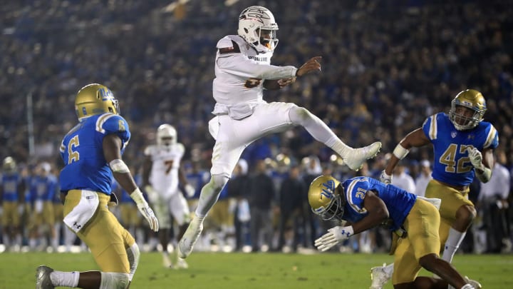 PASADENA, CA – NOVEMBER 11: Manny Wilkins #5 of the Arizona State Sun Devils leaps past Adarius Pickett #6, Jamel Cook #21 and Kenny Young #42 of the UCLA Bruins for a touchdown during the first half of a game at the Rose Bowl on November 11, 2017 in Pasadena, California. (Photo by Sean M. Haffey/Getty Images)