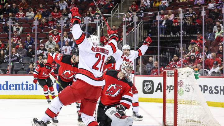 Apr 23, 2022; Newark, New Jersey, USA; Carolina Hurricanes right wing Jesper Fast (71) and right wing Nino Niederreiter (21) reacts after a Hurricanes goal past New Jersey Devils goaltender Jon Gillies (32) during the third period at Prudential Center. Mandatory Credit: Vincent Carchietta-USA TODAY Sports