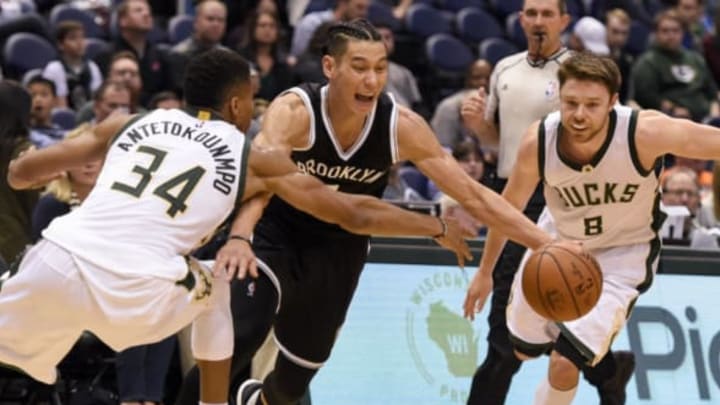 Oct 29, 2016; Milwaukee, WI, USA; Brooklyn Nets guard Jeremy Lin (7) dribbles the ball between Milwaukee Bucks forward Giannis Antetokounmpo (34) and guard Matthew Dellavedova (8) in the third quarter at BMO Harris Bradley Center. Mandatory Credit: Benny Sieu-USA TODAY Sports