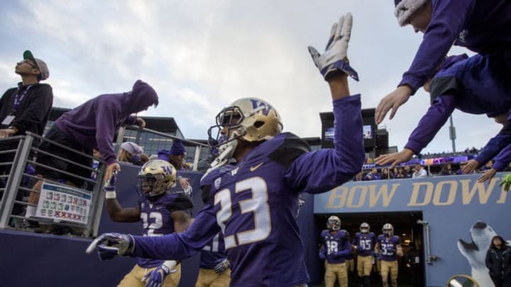 Nov 19, 2016; Seattle, WA, USA; Washington Huskies defensive back Jordan Miller (23) high-fives fans as he comes out onto the field to warm-up before a game against the Arizona State Sun Devils at Husky Stadium. Mandatory Credit: Jennifer Buchanan-USA TODAY Sports