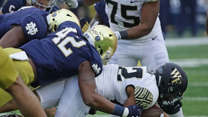 SOUTH BEND, IN - NOVEMBER 04: Matt Colburn #22 of the Wake Forest Demon Deacons is dropped by Julian Okwara #42 of the Notre Dame Fighting Irishat Notre Dame Stadium on November 4, 2017 in South Bend, Indiana. Notre Dame defeated Wake Forest 48-37. (Photo by Jonathan Daniel/Getty Images)
