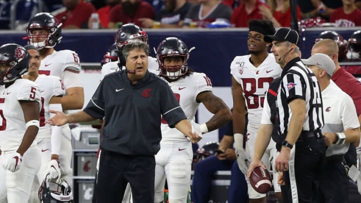 HOUSTON, TEXAS - SEPTEMBER 13: Head coach Mike Leach of the Washington State Cougars questions a penalty with had linesman Jon Stablie during the second quarter against the Houston Cougars during the Texas Kickoff at NRG Stadium on September 13, 2019 in Houston, Texas. (Photo by Bob Levey/Getty Images)