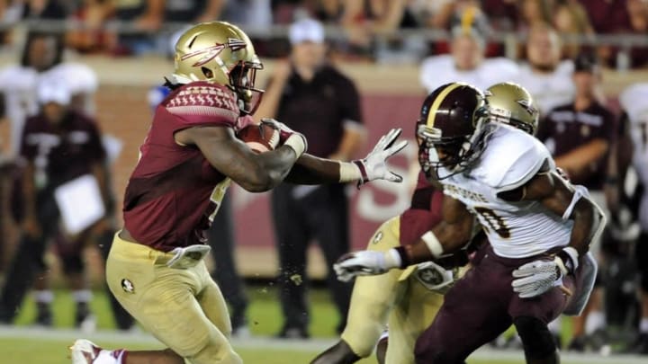 Sep 5, 2015; Tallahassee, FL, USA; Florida State Seminoles running back Dalvin Cook (4) stiff arms Texas State Bobcats safety Stephan Johnson (20) during the first half of the game at Doak Campbell Stadium. Mandatory Credit: Melina Vastola-USA TODAY Sports