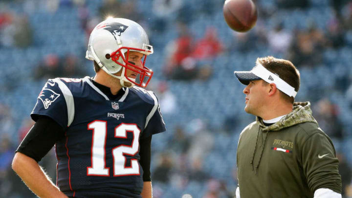 FOXBORO, MA - NOVEMBER 26: Tom Brady #12 of the New England Patriots reacts with offensive coordinator Josh McDaniels before a game against the Miami Dolphins at Gillette Stadium on November 26, 2017 in Foxboro, Massachusetts. (Photo by Jim Rogash/Getty Images)