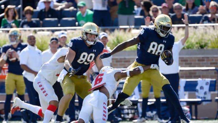 SOUTH BEND, INDIANA - SEPTEMBER 14: Javon McKinley #88 of the Notre Dame Fighting Irish breaks a tackle to score a touchdown in the second quarter against the New Mexico Lobos at Notre Dame Stadium on September 14, 2019 in South Bend, Indiana. (Photo by Quinn Harris/Getty Images)