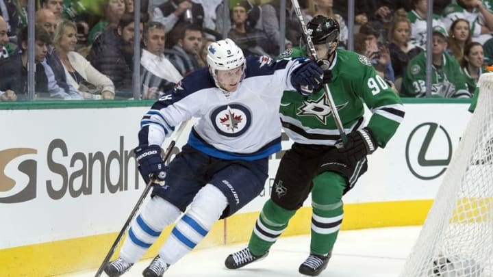 Jan 7, 2016; Dallas, TX, USA; Winnipeg Jets defenseman Jacob Trouba (8) keeps the puck away from Dallas Stars center Jason Spezza (90) during the second period at the American Airlines Center. Mandatory Credit: Jerome Miron-USA TODAY Sports