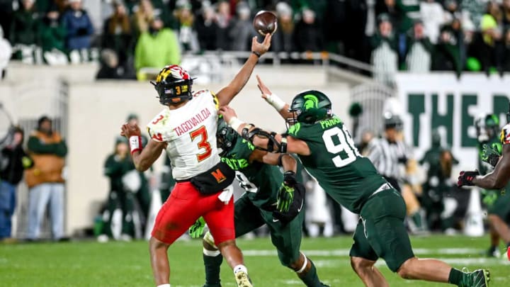 Michigan State’s Jacub Panasiuk, right, and Itayvion Brown pressure Maryland’s quarterback Taulia Tagovailoa during the fourth quarter on Saturday, Nov. 13, 2021, at Spartan Stadium in East Lansing.211113 Msu Maryland 178a