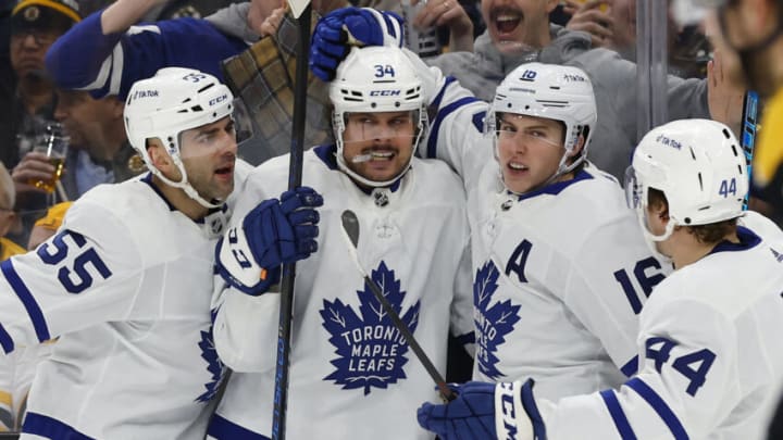 Mar 29, 2022; Boston, Massachusetts, USA; Toronto Maple Leafs right wing Mitchell Marner (16) is congratulated after scoring against the Boston Bruins by center Auston Matthews (34), defenseman Mark Giordano (55) and defenseman Morgan Rielly (44) during the second period at TD Garden. Mandatory Credit: Winslow Townson-USA TODAY Sports