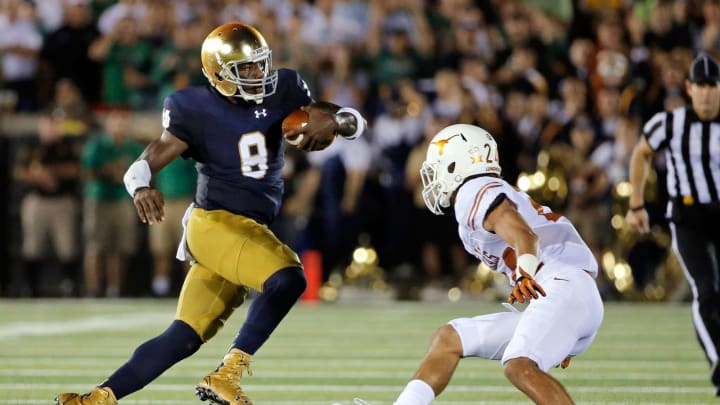 SOUTH BEND, IN – SEPTEMBER 05: Malik Zaire #8 of the Notre Dame Fighting Irish evades the tackle of John Bonney #24 of the Texas Longhorns during the second quarter at Notre Dame Stadium on September 5, 2015 in South Bend, Indiana. The Notre Dame Fighting Irish won 38-3. (Photo by Jon Durr/Getty Images)