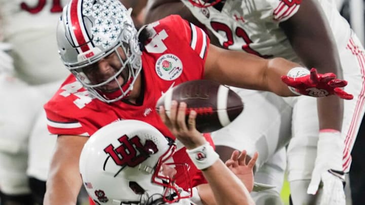 Sat., Jan. 1, 2022; Pasadena, California, USA; Ohio State Buckeyes defensive lineman J.T. Tuimoloau (44) tackles Utah Utes quarterback Cameron Rising (7) during the fourth quarter of the 108th Rose Bowl Game between the Ohio State Buckeyes and the Utah Utes at the Rose Bowl.Rose Bowl Game Ohio State Buckeyes Against Utah Utes Sat., Jan. 1, 2022; Pasadena, California, USA; Ohio State Buckeyes defensive lineman J.T. Tuimoloau (44) tackles Utah Utes quarterback Cameron Rising (7) during the fourth quarter of the 108th Rose Bowl Game between the Ohio State Buckeyes and the Utah Utes at the Rose Bowl.Rose Bowl Game Ohio State Buckeyes Against Utah Utes
