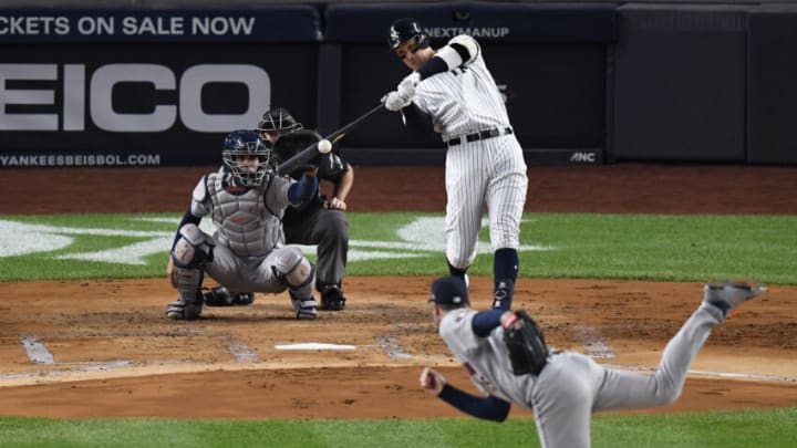 Oct 18, 2019; Bronx, NY, USA; New York Yankees right fielder Aaron Judge (99) hits a single against Houston Astros starting pitcher Justin Verlander (35) during the first inning of game five in the 2019 ALCS playoff baseball series at Yankee Stadium. Mandatory Credit: Robert Deutsch-USA TODAY Sports