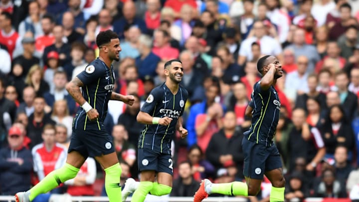LONDON, ENGLAND - AUGUST 12: Raheem Sterling of Manchester City celebrates after scoring his team's first goal with Kyle Walker and Riyad Mahrez during the Premier League match between Arsenal FC and Manchester City at Emirates Stadium on August 12, 2018 in London, United Kingdom. (Photo by Michael Regan/Getty Images)