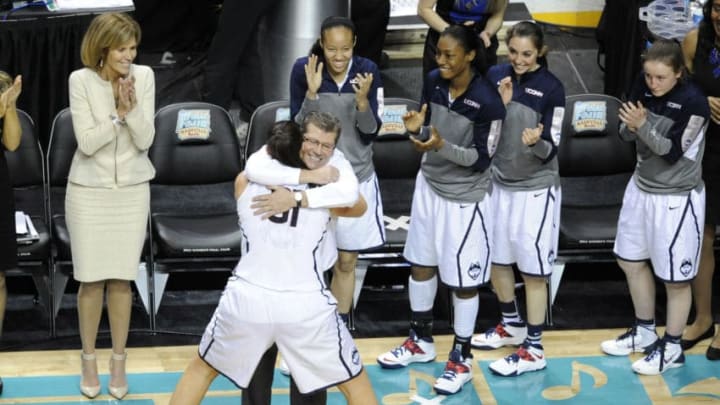 Apr 8, 2014; Nashville, TN, USA; Connecticut Huskies head coach Geno Auriemma hugs center Stefanie Dolson (31) during the second half of the championship game of the Final Four in the 2014 NCAA Womens Division I Championship tournament at Bridgestone Arena. Connecticut wins 79-58. Mandatory Credit: Joshua Lindsey-USA TODAY Sports