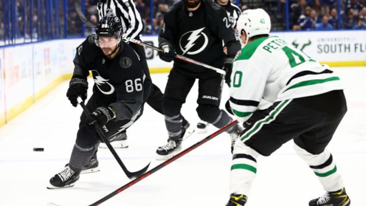 wJan 15, 2022; Tampa, Florida, USA; Tampa Bay Lightning right wing Nikita Kucherov (86) passes the puck as Dallas Stars center Jacob Peterson (40) defends during the third period at Amalie Arena. Mandatory Credit: Kim Klement-USA TODAY Sports