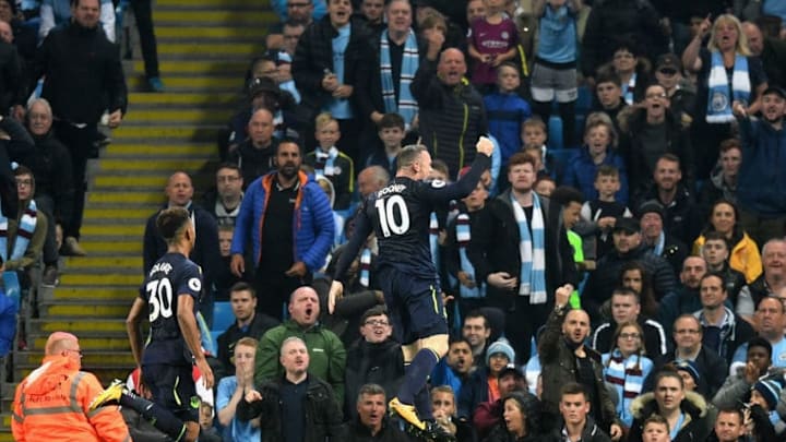 MANCHESTER, ENGLAND - AUGUST 21: Fans watch on as Wayne Rooney of Everton celebrates after scoring his sides first goal during the Premier League match between Manchester City and Everton at Etihad Stadium on August 21, 2017 in Manchester, England. (Photo by Michael Regan/Getty Images)
