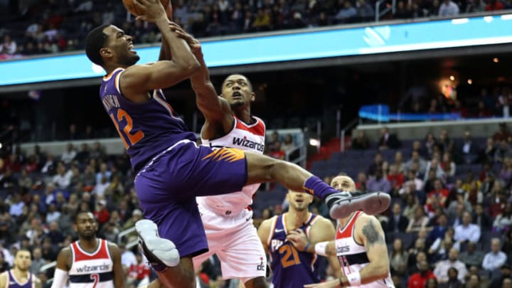 WASHINGTON, DC - NOVEMBER 01: TJ Warren #12 of the Phoenix Suns is fouled by Bradley Beal #3 of the Washington Wizards during the second half at Capital One Arena on November 01, 2017 in Washington, DC. NOTE TO USER: User expressly acknowledges and agrees that, by downloading and or using this photograph, User is consenting to the terms and conditions of the Getty Images License Agreement. (Photo by Patrick Smith/Getty Images)