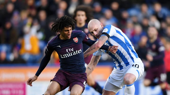 HUDDERSFIELD, ENGLAND - FEBRUARY 09: Aaron Mooy of Huddersfield Town is challenged by Mohamed Elneny of Arsenal during the Premier League match between Huddersfield Town and Arsenal FC at John Smith's Stadium on February 9, 2019 in Huddersfield, United Kingdom. (Photo by Gareth Copley/Getty Images)