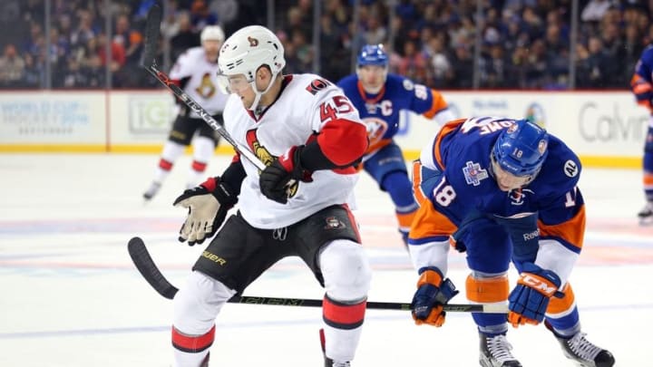 Mar 23, 2016; Brooklyn, NY, USA; Ottawa Senators defenseman Chris Wideman (45) and New York Islanders center Ryan Strome (18) battle for the puck during the second period at Barclays Center. Mandatory Credit: Brad Penner-USA TODAY Sports