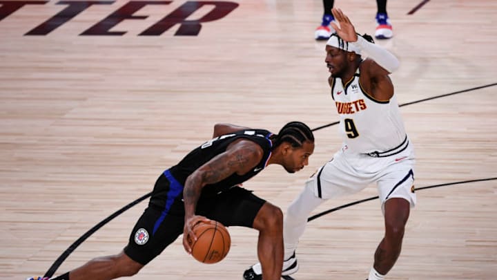 LAKE BUENA VISTA, FLORIDA - SEPTEMBER 03: Kawhi Leonard #2 of the LA Clippers drives the ball against Jerami Grant #9 of the Denver Nuggets during the third quarter in Game One of the Western Conference Second Round during the 2020 NBA Playoffs at AdventHealth Arena at the ESPN Wide World Of Sports Complex on September 03, 2020 in Lake Buena Vista, Florida. NOTE TO USER: User expressly acknowledges and agrees that, by downloading and or using this photograph, User is consenting to the terms and conditions of the Getty Images License Agreement. (Photo by Douglas P. DeFelice/Getty Images)